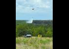 A Nebraska Army National Guard CH-47 Chinook helicopter drops water on a hot spot near the Niobrara River. Dry lightning sparked about 20 wildfires along Highway 11 north of Atkinson. Photo by Seth Peterson of the Nebraska Forest Service.	