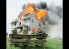 Three Maxwell firefighters watch the house burn after fire training was completed inside. The house, located in Polk County, was burned as part of a training exercise on May 4. Firefighters from Collins, Elkhart and Maxwell participated.